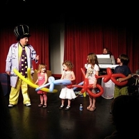 The Ballooniac on stage with his helpers